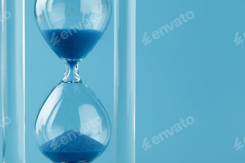 Preview: Close up of sandglass on paper background