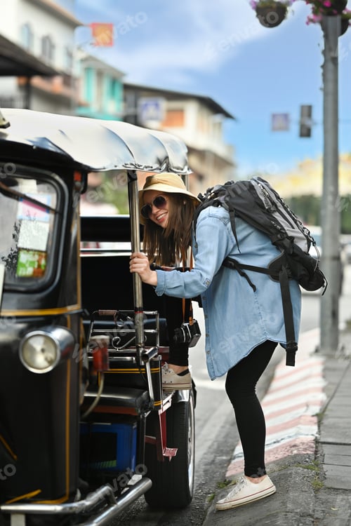 Preview: Caucasian female tourist with backpack on holiday vacation trip in Thailand.
