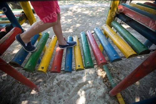 Preview: Boy walking on jungle gym at playground