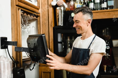 Preview: Waiter bartender small business owner checking bill before printing it on digital cash register.