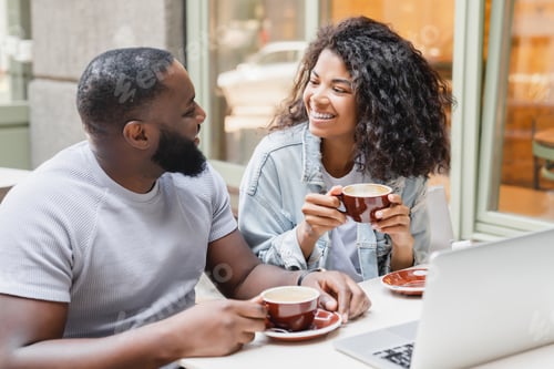 Preview: Smiling Couple Enjoying Coffee at an Urban Cafe