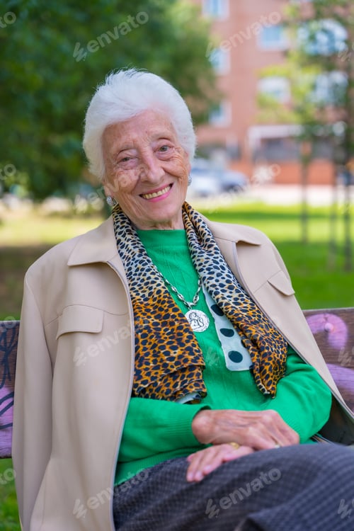 Preview: Portrait of an elderly woman sitting on a chair in the garden of a nursing home