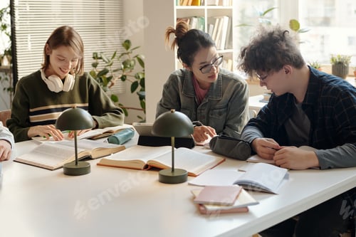 Preview: Group of Teen Students Collaborating at Desk in Study Room
