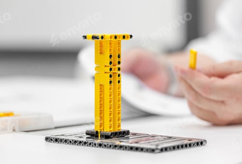 Preview: Lego constructor on the table at school, hand in frame