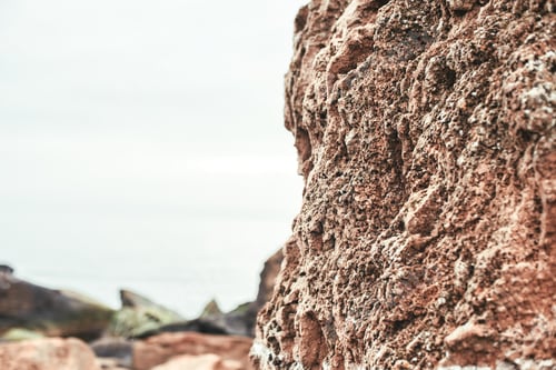 Preview: Close up photo of old stone brown wall on the beach