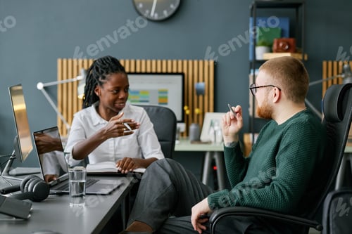 Preview: Discussing Ideas During Team Meeting in Modern Office