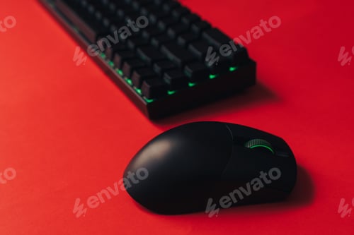 Preview: Computer wireless gaming mouse and keyboard with green backlight against red background