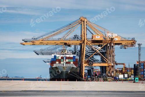 Preview: A large cargo ship is docked at a commercial port