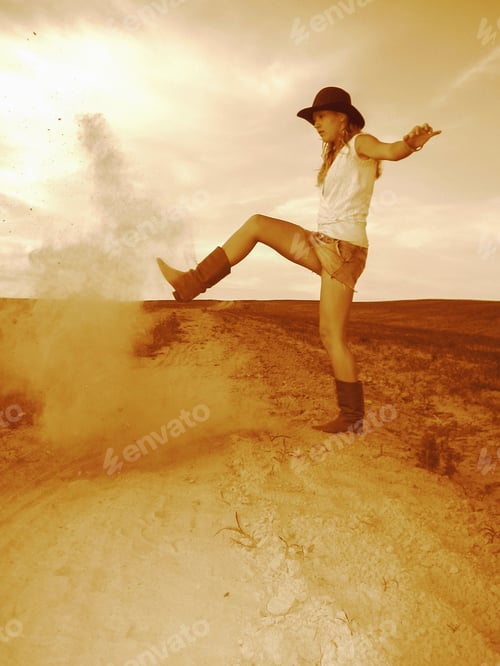 Preview: Cowgirl woman throwing sand on the road