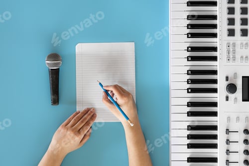 Preview: Musical keys, microphone and blank paper on a blue background.