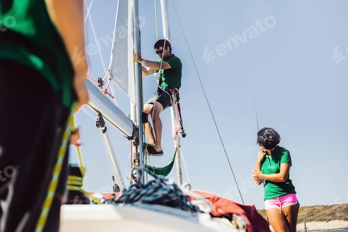 Preview: Man on rope on sail boat, woman watching