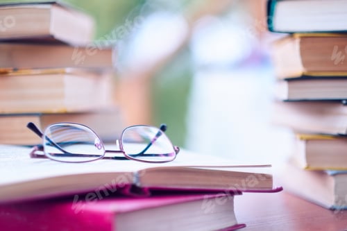 Preview: glasses and open book. best books home library background.