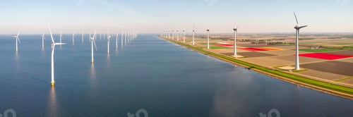 Preview: Windmill turbines at sea seen from a drone aerial view from above at a huge winmill park