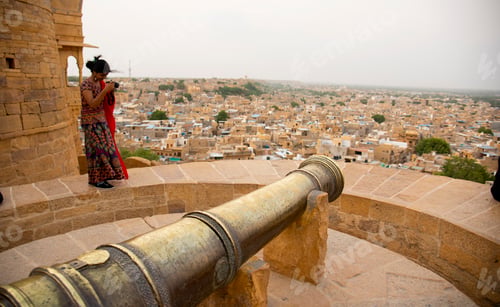Preview: Woman tourist taking photos of Jaisalmer city from Golden Fort.