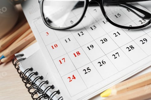Preview: Daily planning with a calendar and reading glasses on a workspace