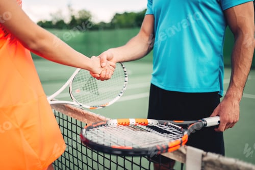 Preview: Man and woman partners on outdoor tennis court