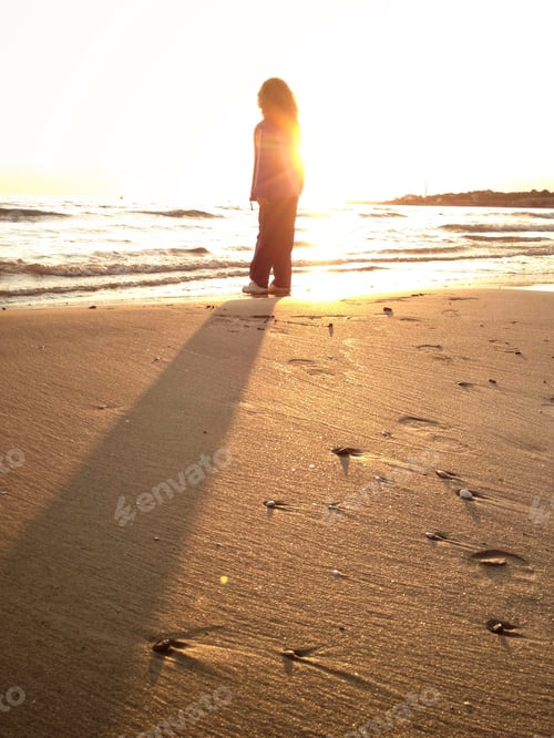 Preview: Child Standing at Beach at Sunrise
