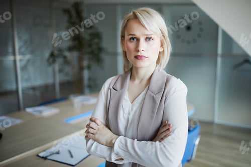 Confident Business Woman in Boardroom with Arms Crossed