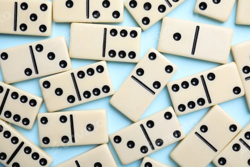 Preview: Classic domino tiles on light blue background, flat lay