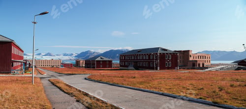 Preview: Historic buildings of Pyramiden, Svalbard under clear skies and distant mountains in summer