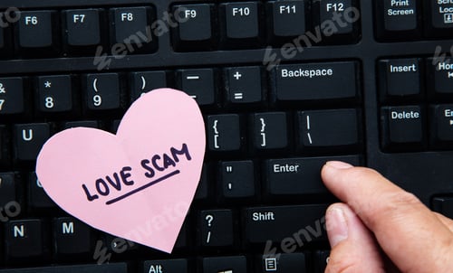 Preview: Hand communicating with scammer via computer.