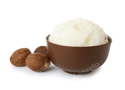 Preview: Shea butter in bowl and nuts isolated on white