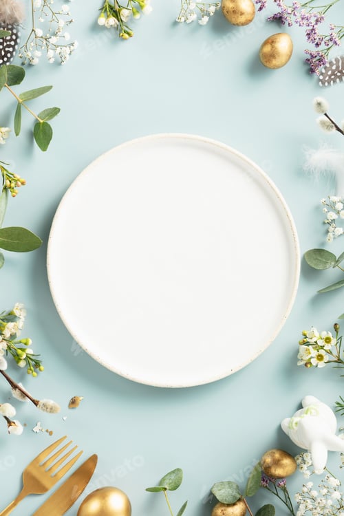 Preview: white plate, golden easter eggs, feathers and spring flowers