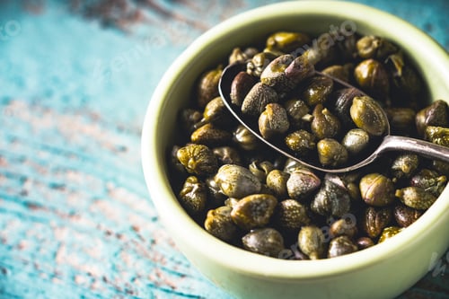 Preview: Capers in the bowl on the light blue background