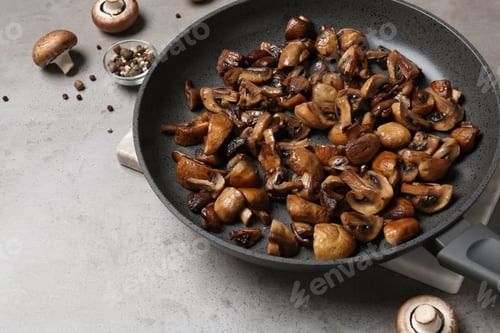 Preview: Frying pan with mushrooms on grey table
