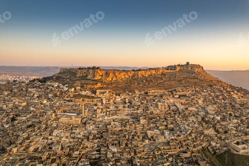 Preview: Traditional pink stone houses of Mardin Old town Mesopotamia in the background- Mardin, Turkey