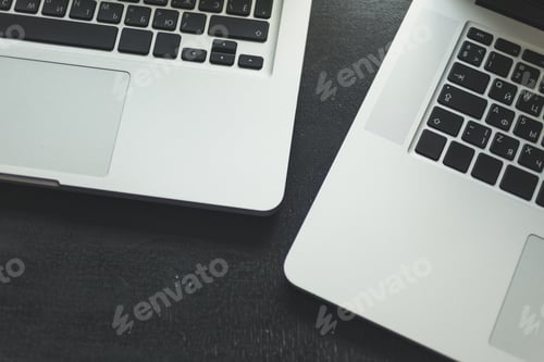 Preview: Two laptops on modern wooden desk
