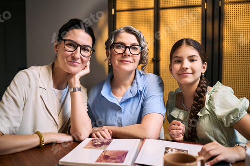 Preview: Portrait of Three Generation Family Women Reviewing Photo Album