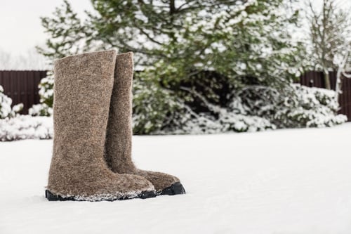 Preview: Winter felt boots standing in snow outdoors