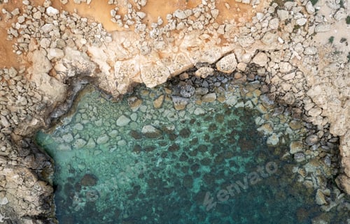 Preview: Drone aerial of rocky sea coastline transparent turquoise water. Seascape top view.