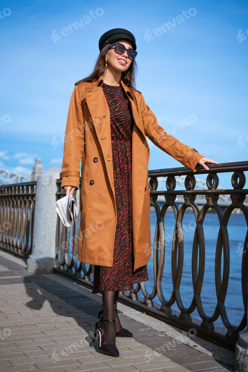 Preview: Young woman on the embankment with a newspaper in hand