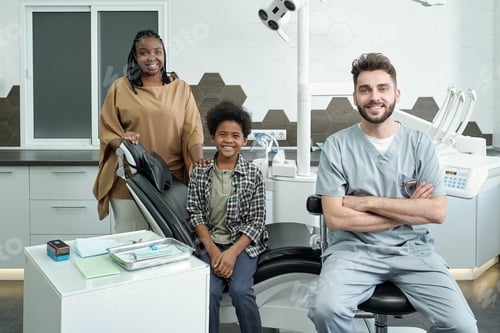 Preview: Happy stomatologist, young African woman and her cute son