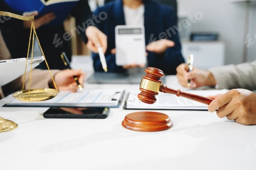 Preview: business people and lawyers discussing contract papers sitting at the table.