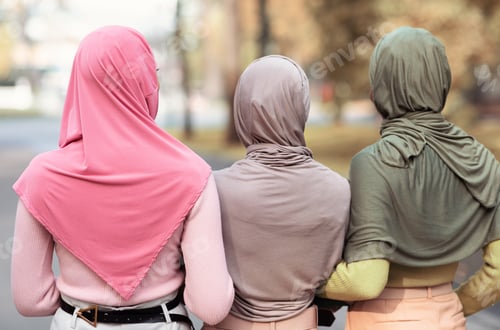 Preview: Three women wearing headscarves walking away outdoors