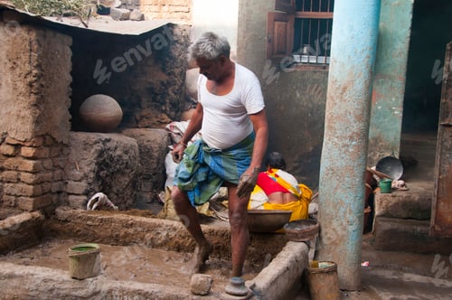 Preview: Potter preparing clay for making pots, India.
