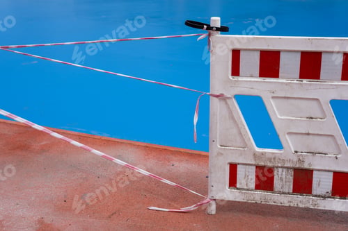 Preview: white barrier with red stripes on the background of stadium.