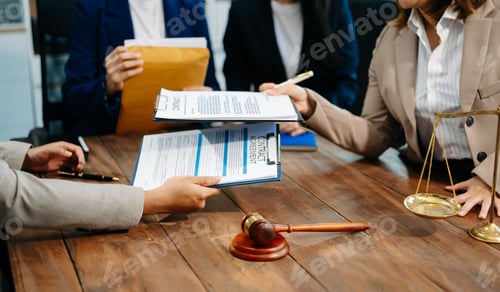 Preview: Business and lawyers discussing contract papers with brass scale on desk in office. Law,
