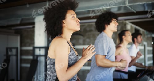 Preview: Group of fit healthy friends people cardio workout in gym