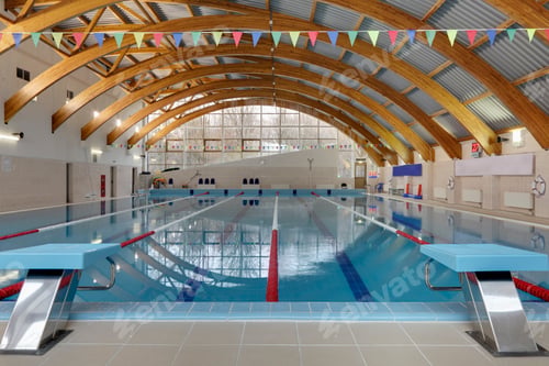 Preview: Indoor swimming pool, starting block, diving block and marked lanes, flat calm water
