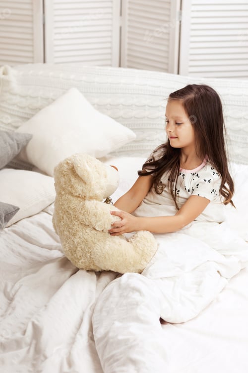 Preview: little child girl playing with teddy bear