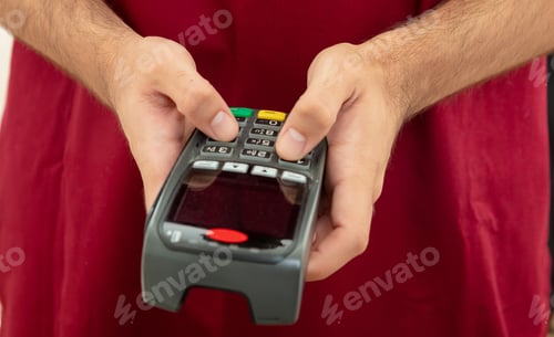 Preview: Man typing on a POS terminal, payment with credit card. Banking, shopping concept.