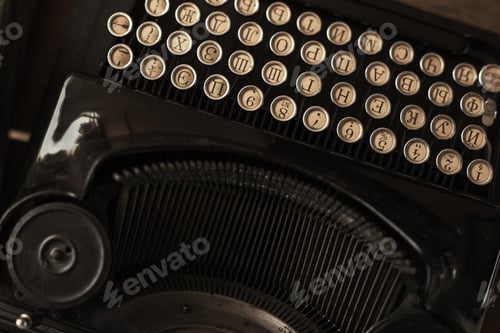 Preview: Old black typewriter with paper worth on the table
