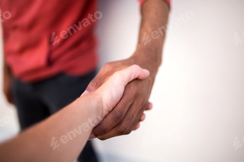 Preview: Close up black man hand shaking hands with caucasian man