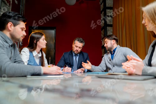 Preview: office workers are sitting at the head of the director discussing a business plan