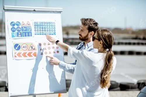 Preview: Driver instructor with student on the training ground outdoors