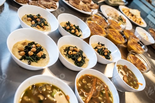 Preview: Group of plates with soups of various types in hot bowls.